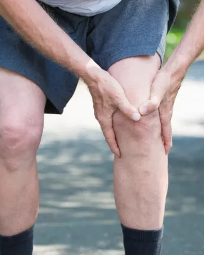 Therapist guiding a patient through knee rehabilitation exercises