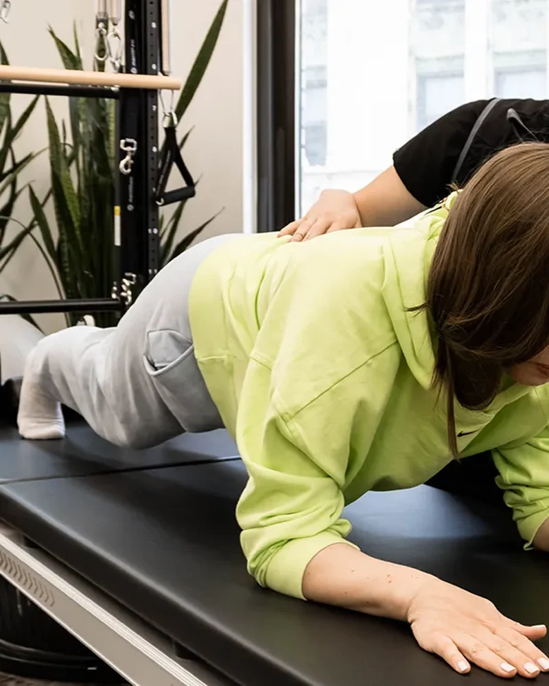 Therapist guiding a patient through hands-on spinal treatment
