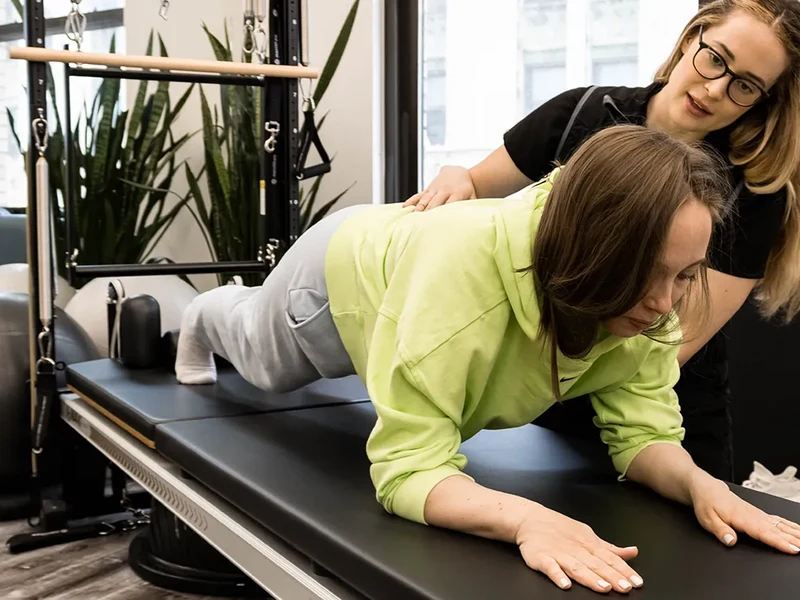 Physical therapist assessing a patient's lower back and spine