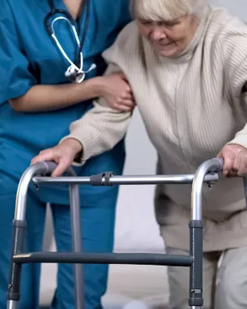 Therapist assisting a patient with hip replacement rehabilitation exercises