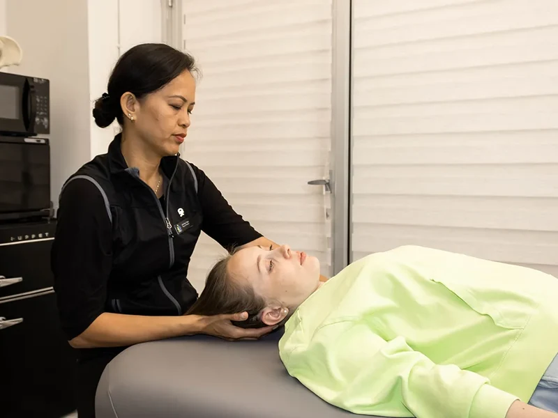 Physical therapist assessing cervical spine mobility