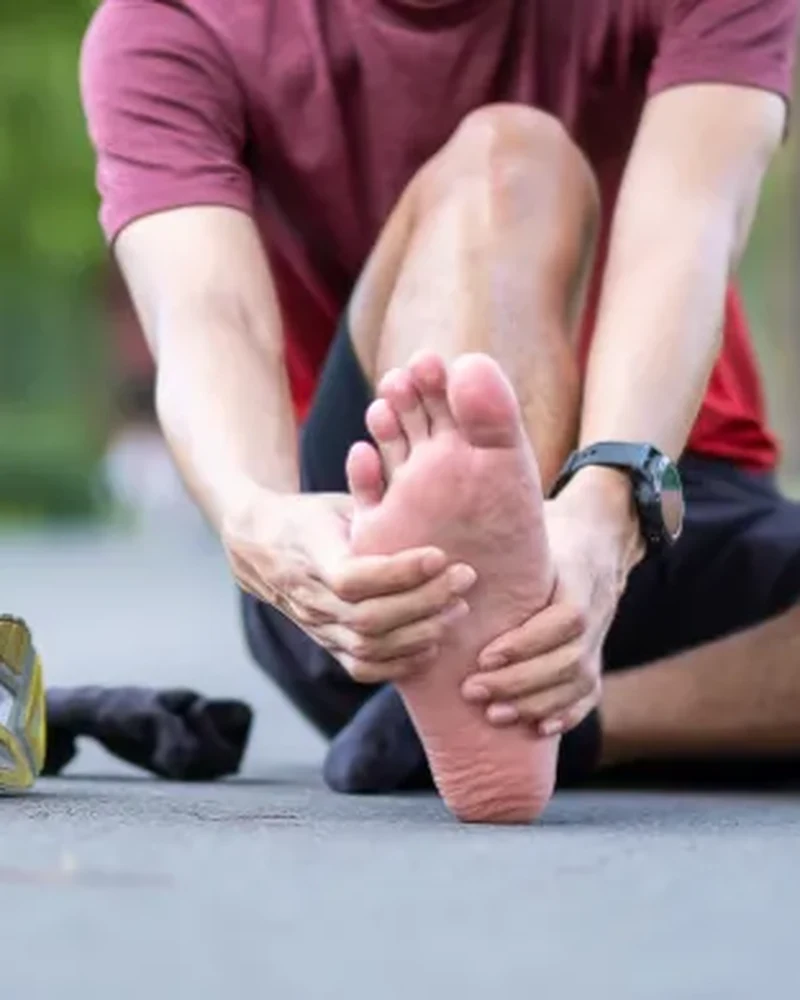 Therapist performing manual therapy on a patient's foot for plantar fasciitis