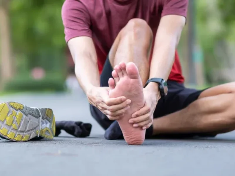 Physical therapist examining a patient's foot and arch