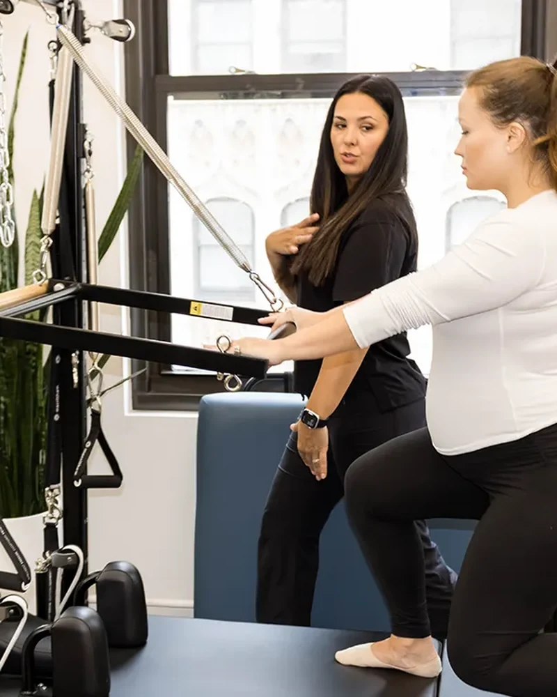 Therapist guiding a postpartum patient through a graded return-to-exercise program