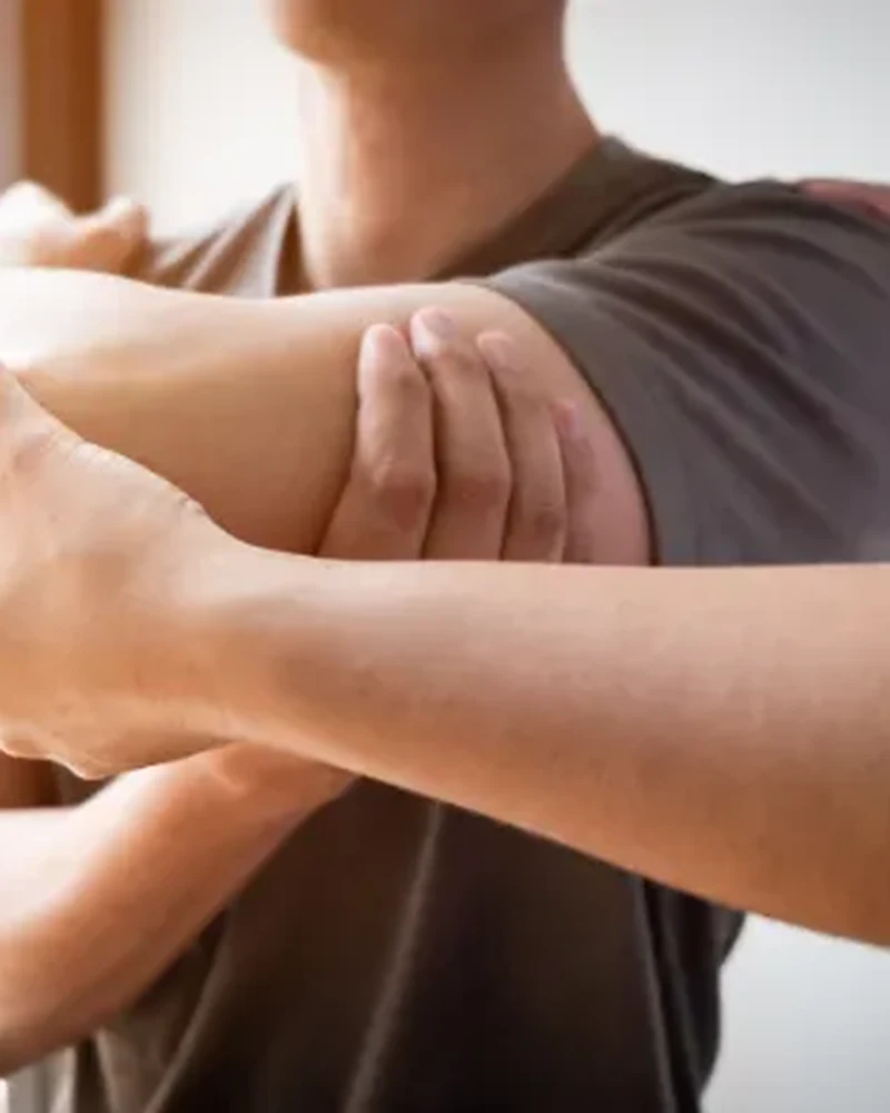 Therapist guiding a patient through rotator cuff strengthening exercises