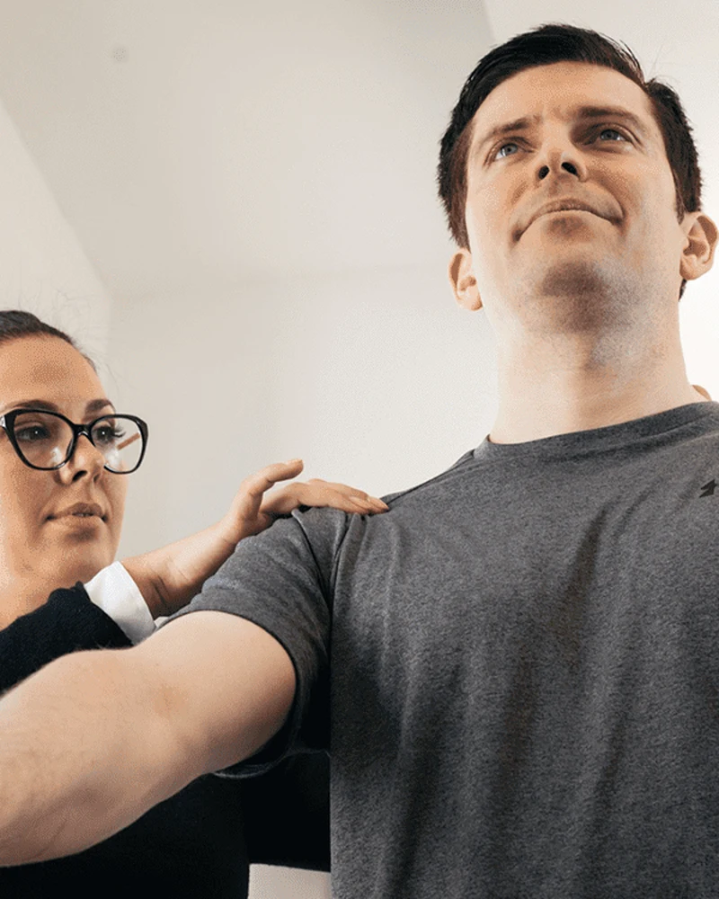 Therapist performing shoulder mobilization and rotator cuff strengthening