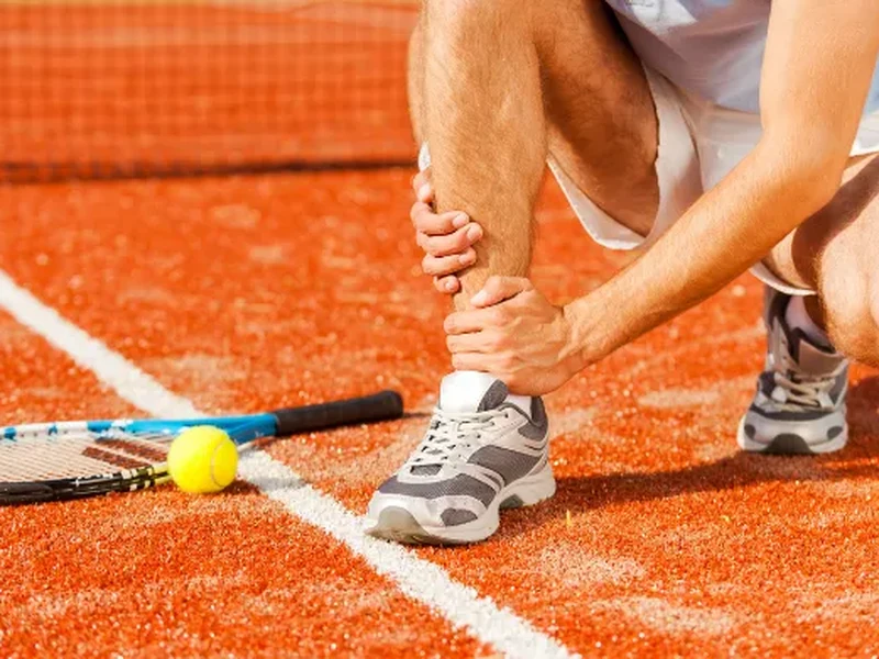 Physical therapist assessing a sports injury with rehabilitation focus