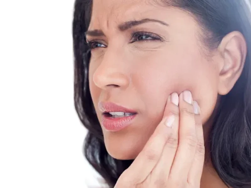 Therapist treating a patient's jaw for TMJ/TMD