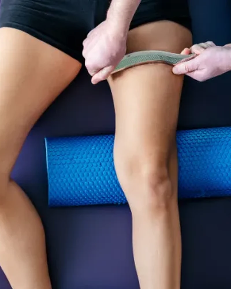 Therapist performing instrument-assisted soft tissue mobilization