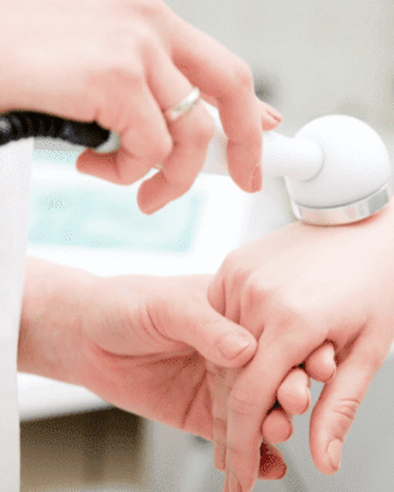 Therapist applying therapeutic ultrasound to a patient's shoulder
